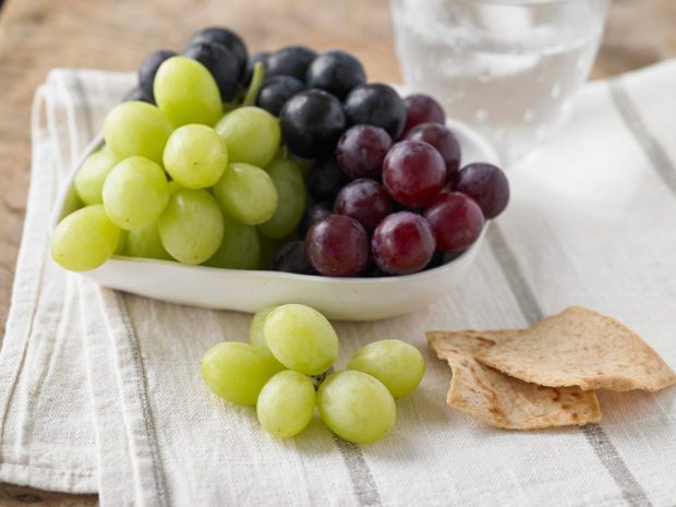 snacking on grapes