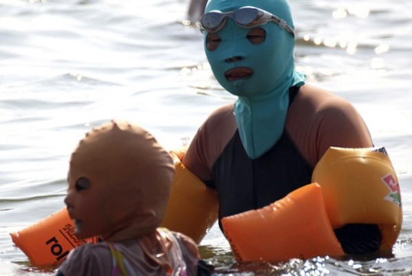 Beach goers wear face-kinis